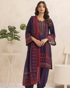 Woman wearing a traditional outfit with a patterned dupatta in a minimalistic setting