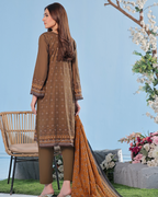 Woman in a brown traditional outfit with a floral background