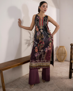Woman wearing a floral embroidered dress with a plain background