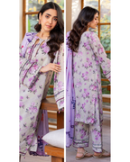 Woman wearing a floral outfit with a purple dupatta indoors.