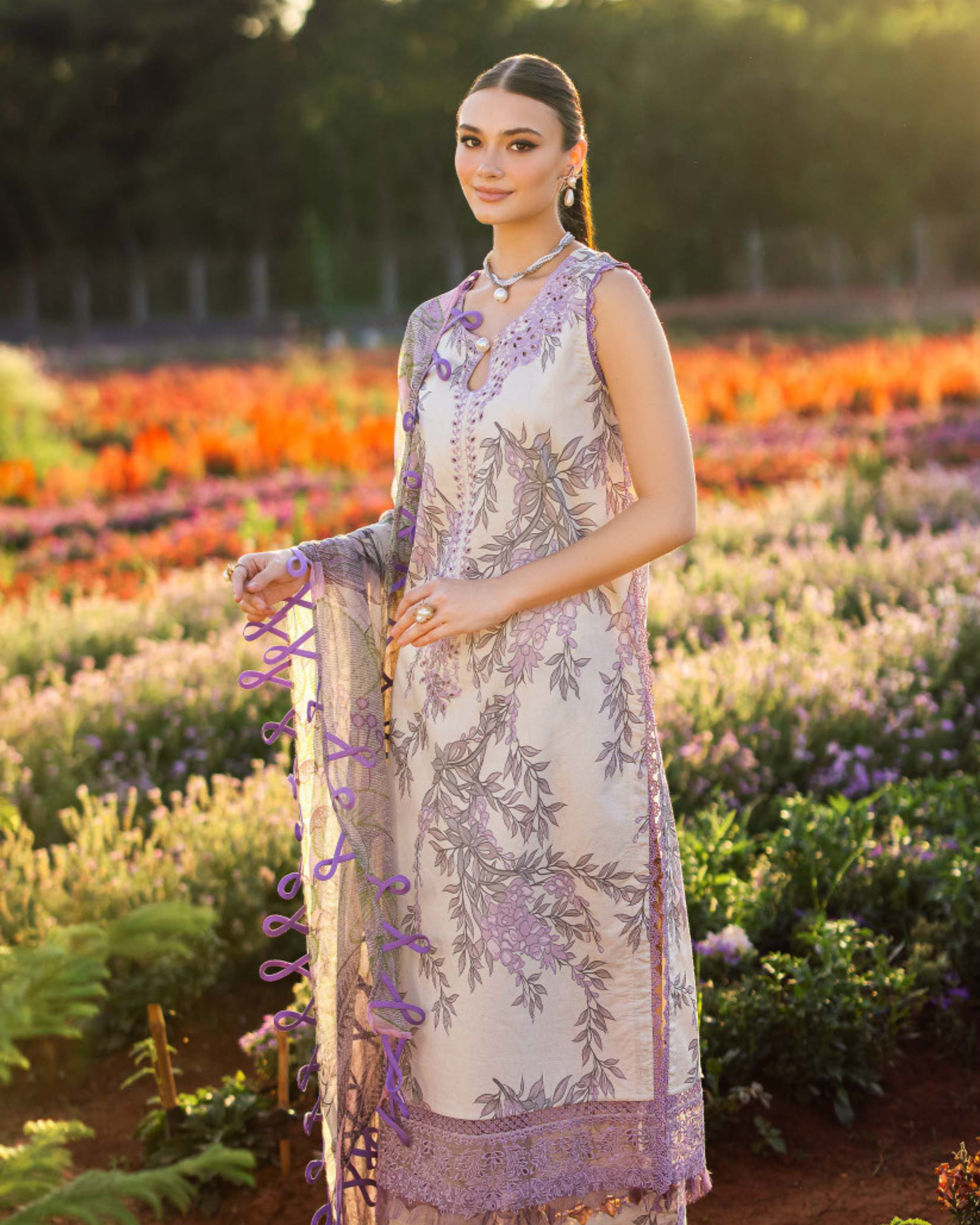 Woman in a floral dress standing in a field of flowers