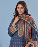 Woman wearing a patterned shawl against a blue background
