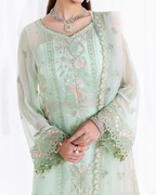 Light green embroidered traditional outfit with a white dupatta on a white background