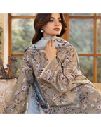 Woman wearing a floral embroidered beige dupatta with a blurred indoor background