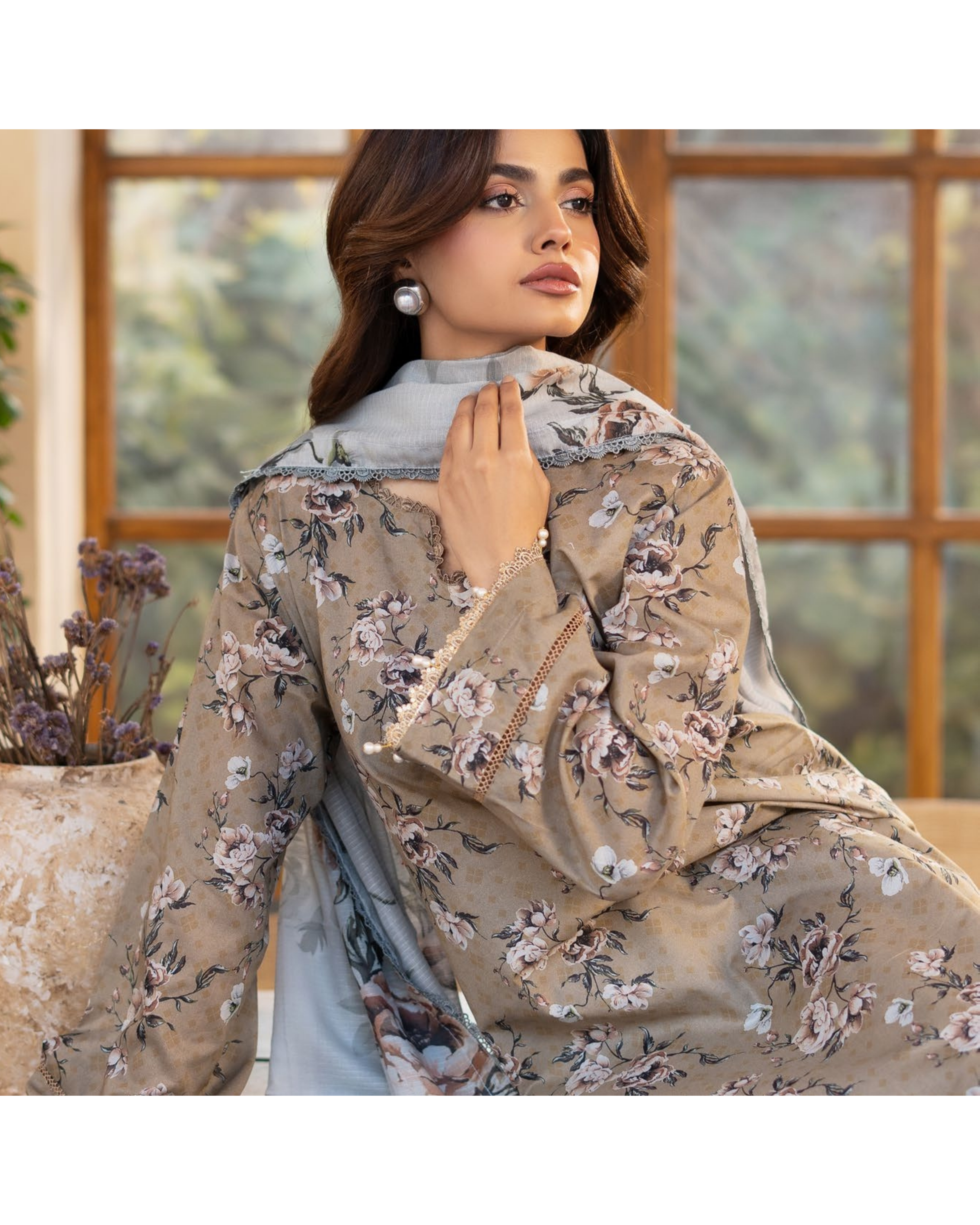 Woman wearing a floral embroidered beige dupatta with a blurred indoor background