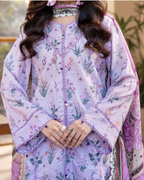 Person wearing a floral embroidered outfit with a blurred background