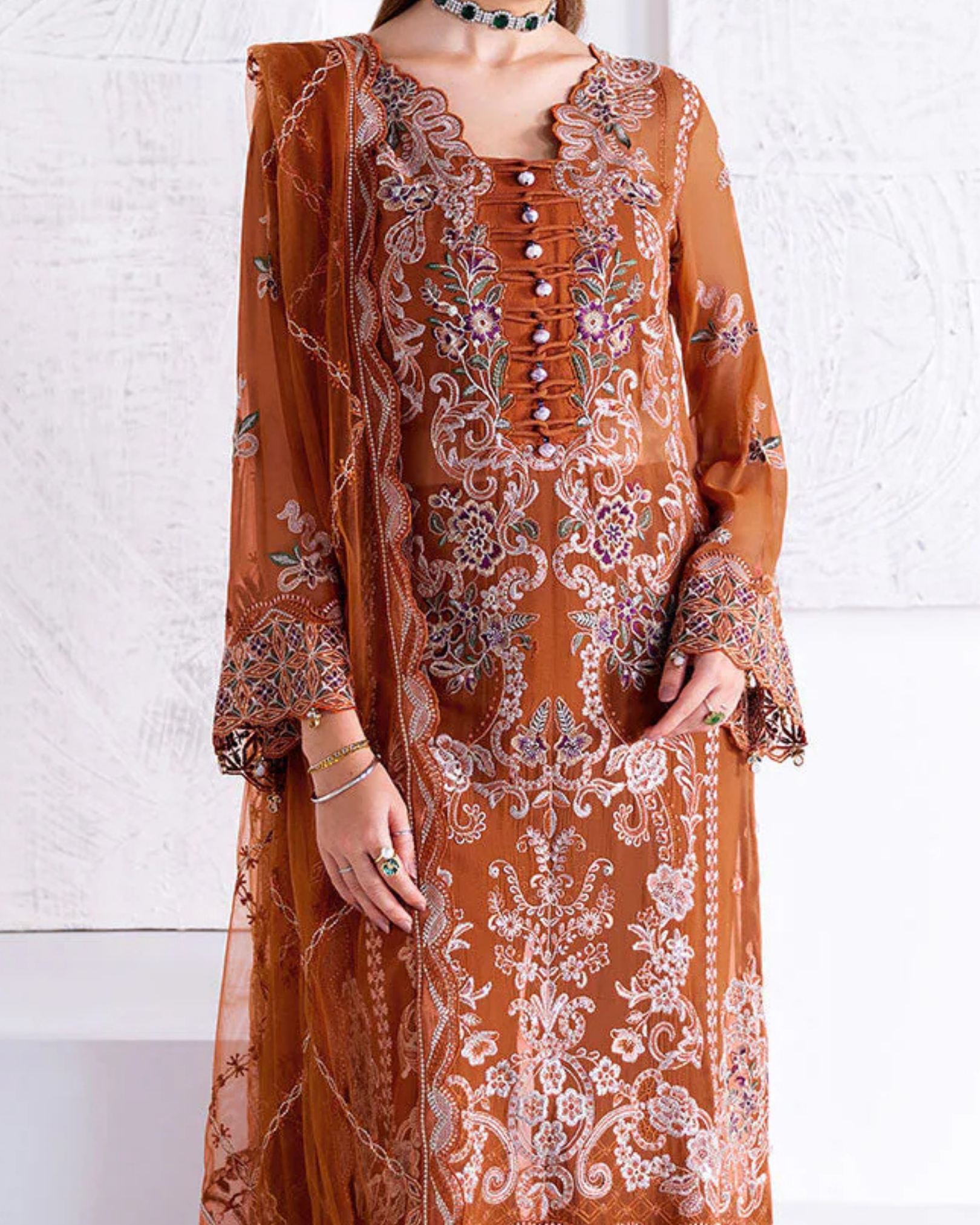 Brown embroidered traditional outfit with a white background