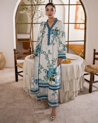 Woman in a floral dress standing in a dining room.
