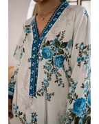Floral patterned garment with blue roses on a light background