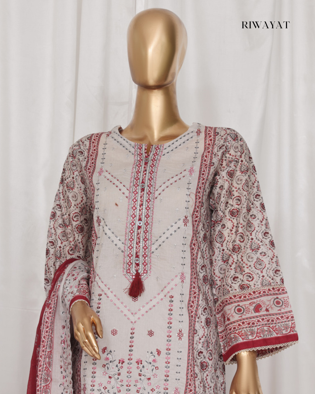 Mannequin wearing a white and red patterned dress with 'RIWAYAT' branding.