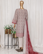 Mannequin wearing a patterned outfit with a red dupatta against a white curtain background