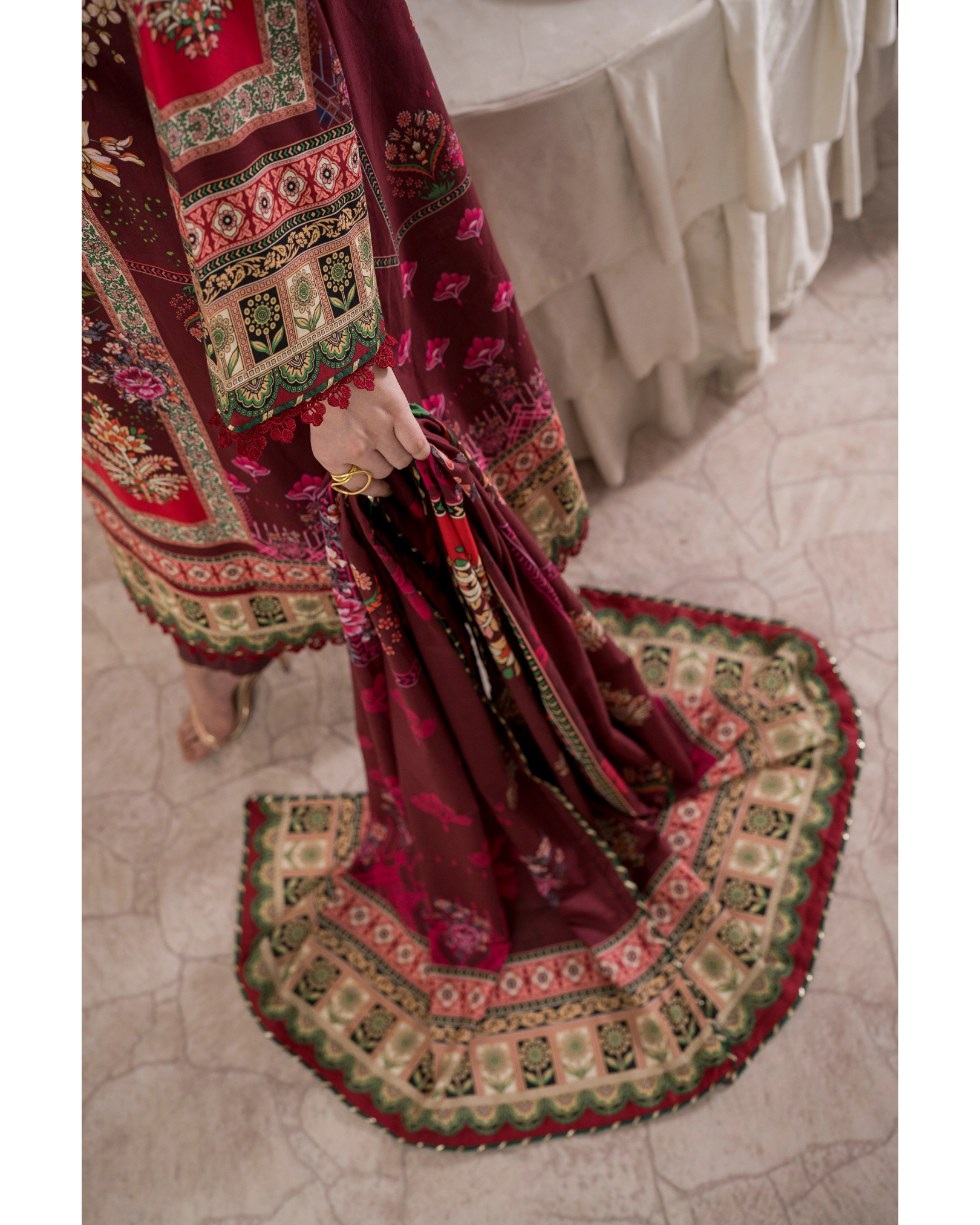 Traditional embroidered fabric with intricate patterns on a textured floor.