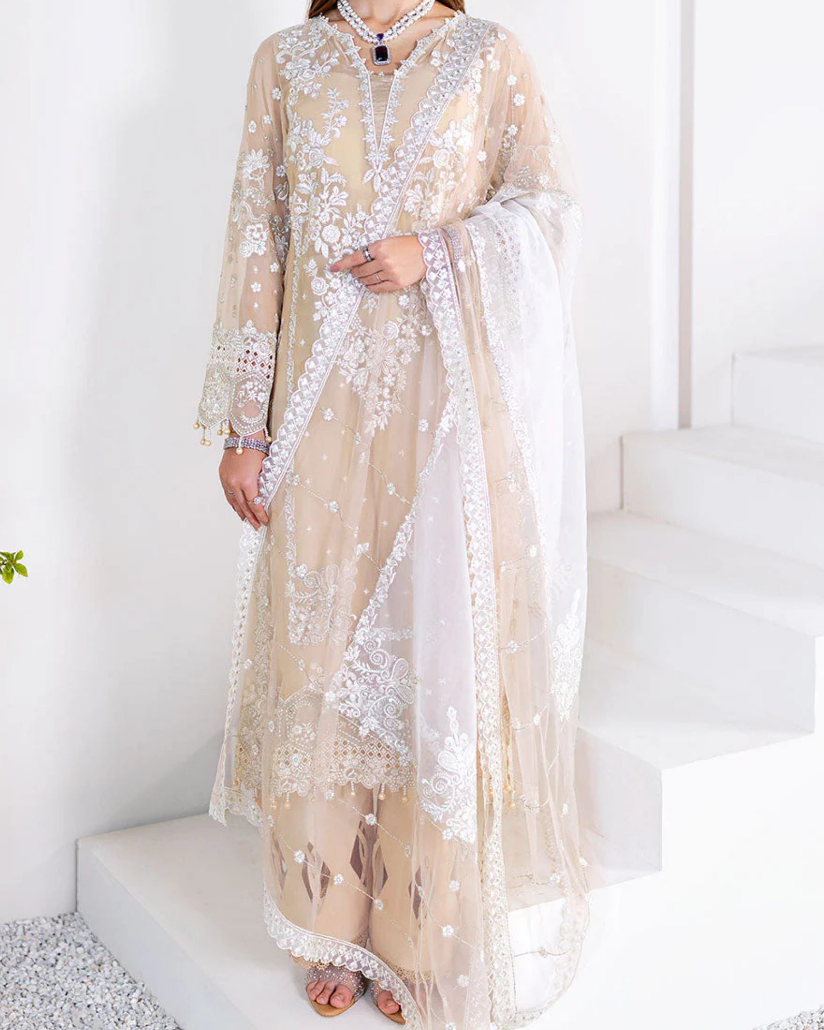 Beige embroidered dress with a white dupatta on a white background