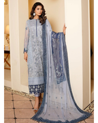 Woman wearing a light blue embroidered traditional outfit with a matching dupatta in an indoor setting.