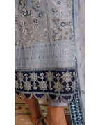 Close-up of a traditional embroidered garment with intricate patterns on a light background