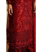 Close-up of a red embroidered garment with intricate patterns.