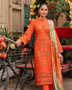 Woman in an orange embroidered outfit standing next to a bicycle with floral decorations.