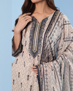 Woman wearing a patterned dress with a blue background