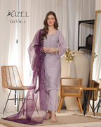 Woman in a purple and white outfit with a sheer dupatta in a room setting, featuring furniture and decor.