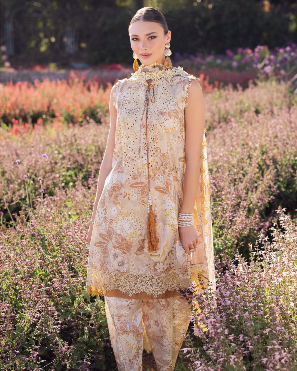 Woman in a floral dress standing in a field of flowers