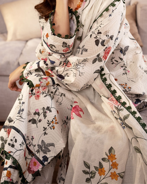 Person wearing a floral-patterned scarf with a neutral background