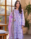 Woman wearing a light purple floral dress with a matching dupatta indoors.
