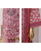 Embroidered fabric with pink and red patterns on a white background
