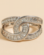 Silver ring with diamond accents on a beige background
