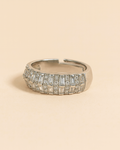 Silver ring with gemstones on a beige background