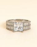 Ring with a large central gemstone and smaller stones on a beige background