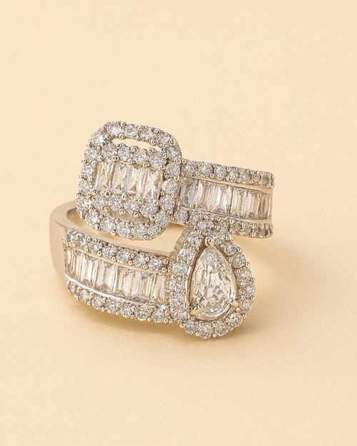 Gold ring with diamond accents on a beige background