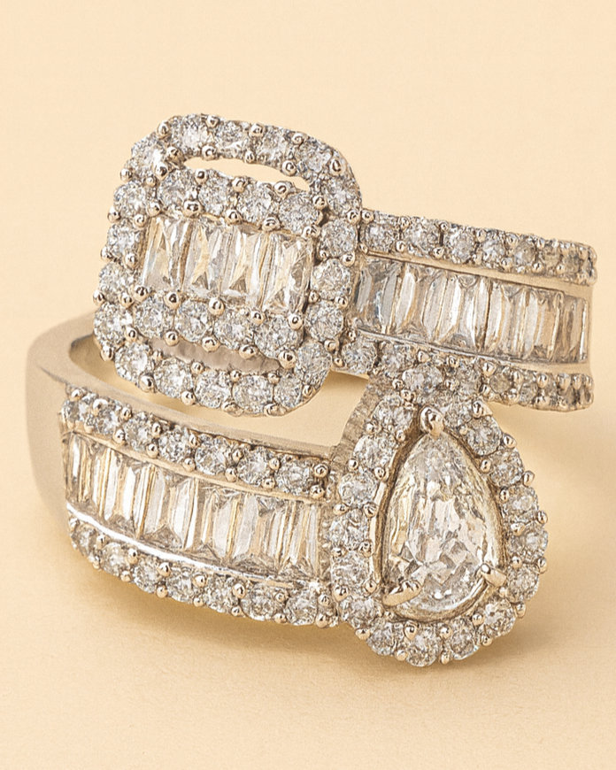 Gold ring with diamond accents on a beige background