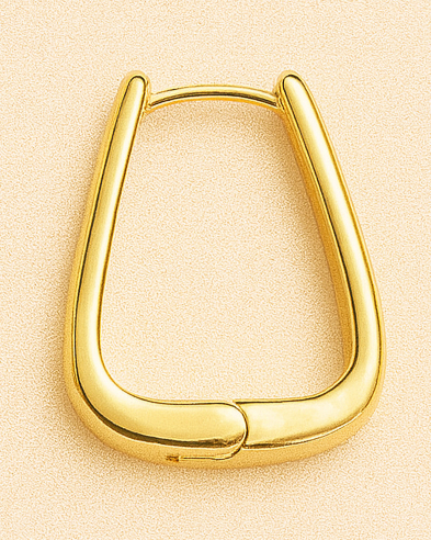 Gold hoop earrings on a beige background