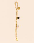 Gold bracelet with star-shaped charms on a beige background