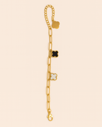 Gold bracelet with star-shaped charms on a beige background
