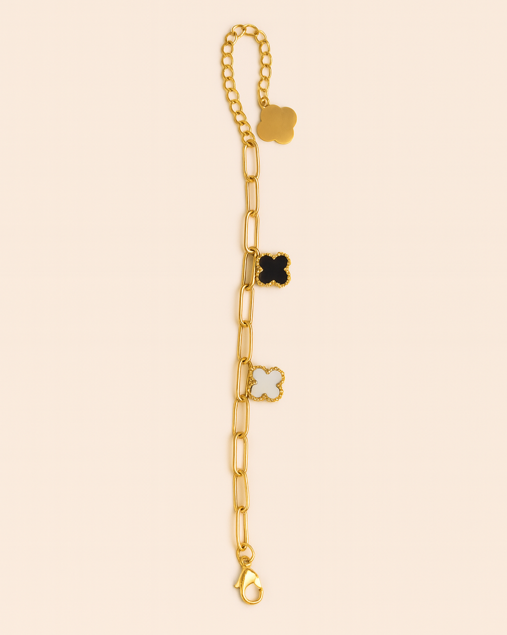 Gold bracelet with star-shaped charms on a beige background