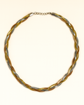 Braided necklace with gold and silver tones on a white background
