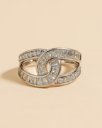 Artificial Anti-Tarnish silver ring with diamond accents on a beige background