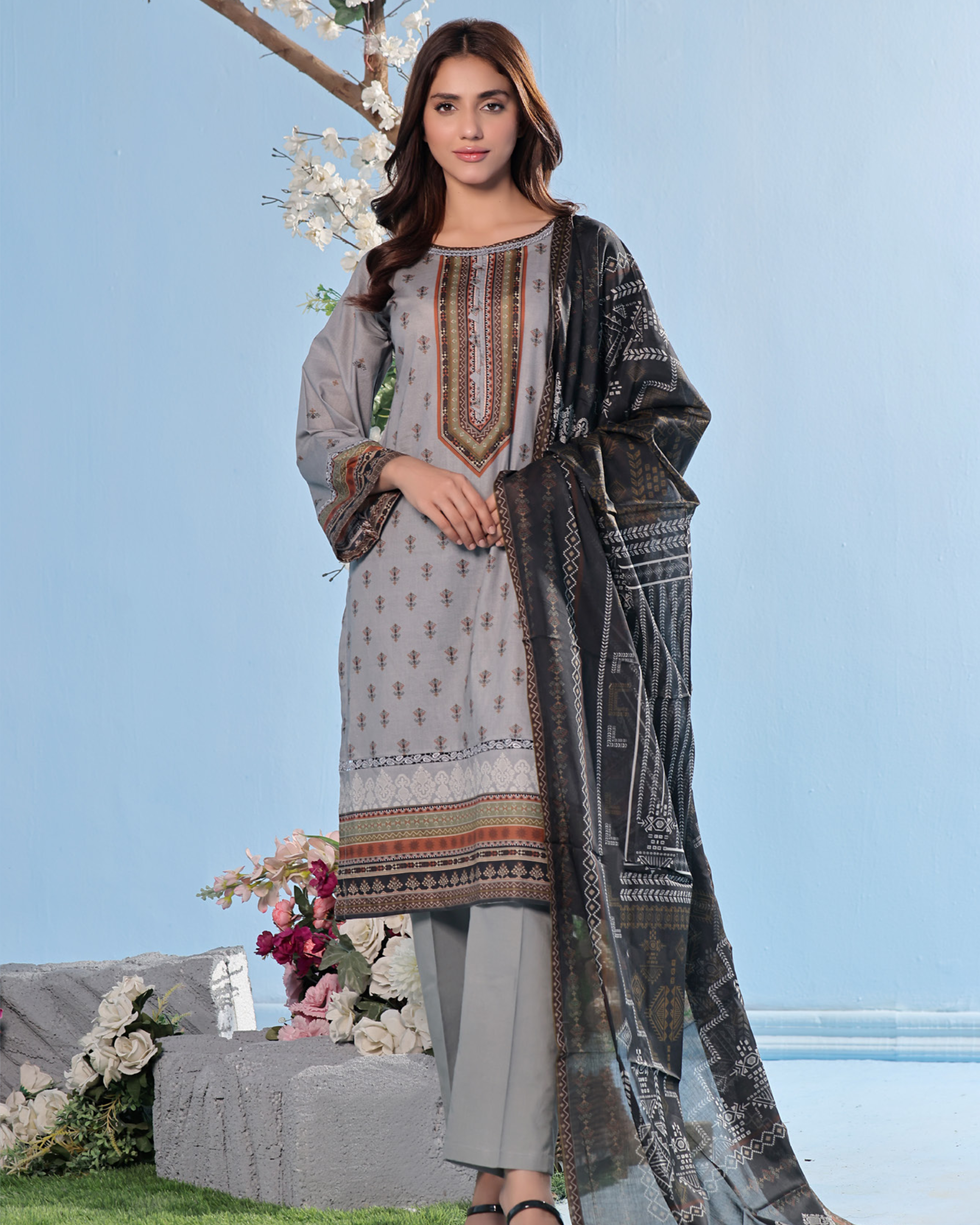 Woman wearing a traditional outfit with a floral background